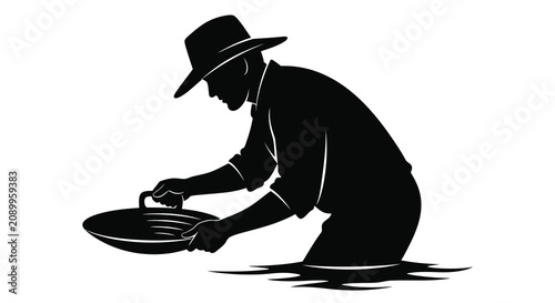 Foto Gold prospector with pan kneeling in water a stark black silhouette miner pannin
