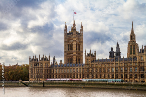 The Palace of Westminster with the Union Jack flag on the River Thames in London
