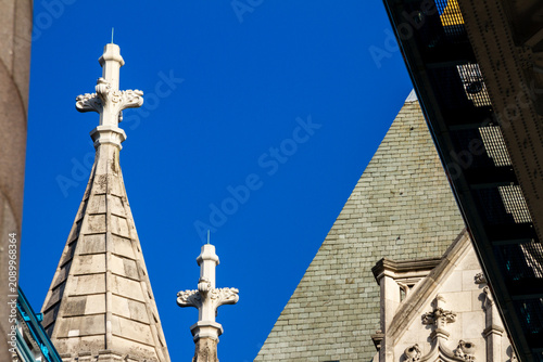 Gothic stone spires and roof details of the Tower Bridge in London