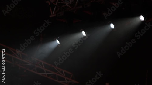 Spotlights in the concert hall. Stage light with colored spotlights and smoke.