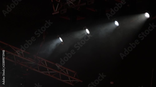 Spotlights in the concert hall. Stage light with colored spotlights and smoke.