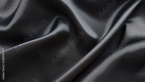Schilderij op canvas Black textured faux leather fabric with soft folds in studio