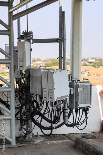 Close up equipment section of Wireless Communication Antenna pole, Mobile phone mast antenna pole on top of dilapidated building