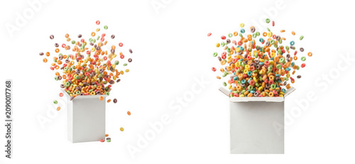 Colorful fruit flavored cereal rings exploding from white boxes isolated on transparent background