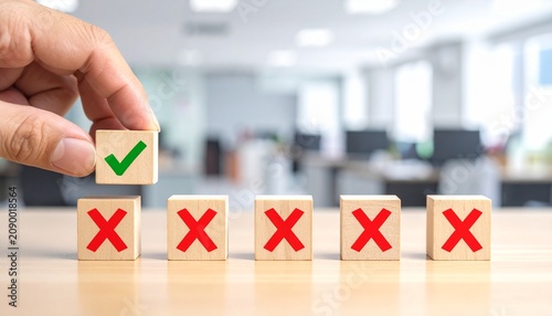 Hand lifting green check cube above red X cubes symbolizing correct choice, success, and decision‑making.
