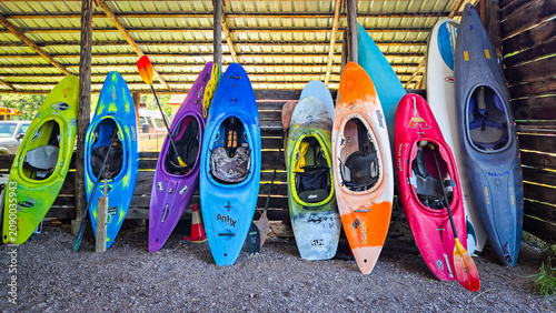 Konstfotografi Colorful kayaks stored in an outdoor wooden shed