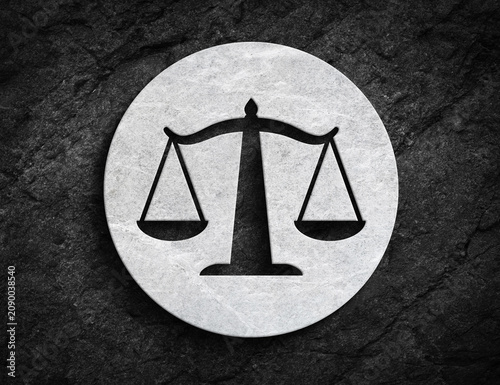 Justice scale symbol carved on stone circle background