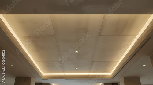 Modern recessed ceiling with warm LED strip lighting creating a dramatic effect.