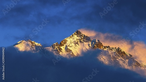 Snow-covered summit of the Weisshorn mountain, illuminated by the evening sun, view from Grimentz, Val d'Anniviers, Valais Alps, Canton Valais, Switzerland
