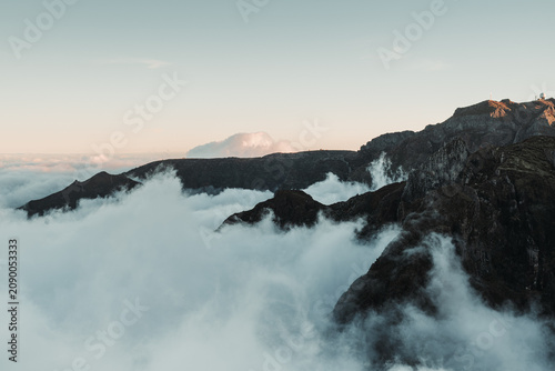 Sunset over the mountains. Mountains shrouded in clouds