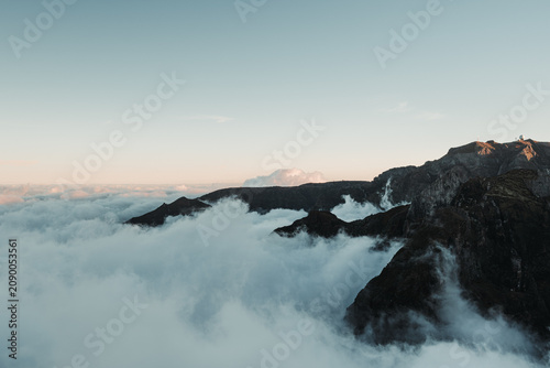 Sunset over the mountains. Mountains shrouded in clouds