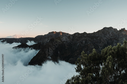 Sunset over the mountains. Mountains shrouded in clouds