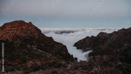 Sunset over the mountains. Mountains shrouded in clouds