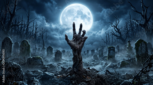 Zombie hand reaching from grave in graveyard under full moon night