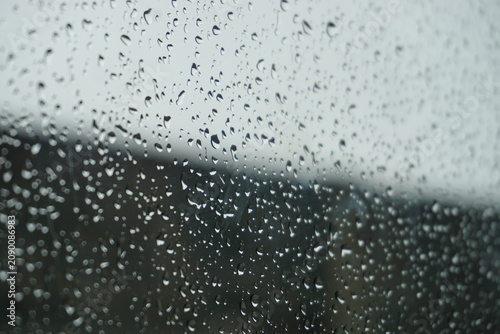 Tableau sur toile rain drops wetting glasses window look dewy
