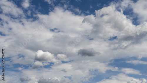Blue sky filled with soft white clouds creating a natural background with generous copy space. Ideal for weather, travel and environmental concepts.