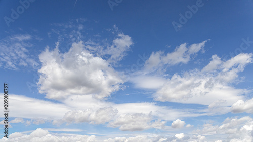 Beautiful blue sky with large white cumulus clouds. Natural cloudscape background with copy space, suitable for weather, climate and nature concepts.