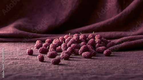 Fresh raspberries on red fabric