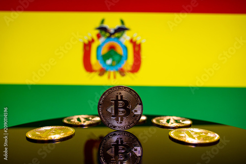 Close up of Bitcoin coins with Bolivia flag background.