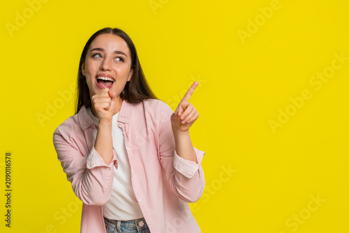 Photography Young woman singing into imaginary microphone with closed eyes, emotionally immersed in performance