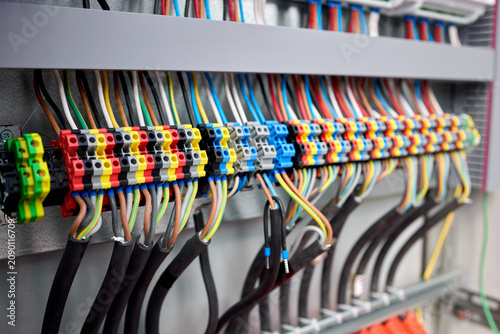 Quadro su tela connected and organized electrical wiring in an indoor panel with a close-up perspective showing terminal blocks and cable ties against a clean background with black and red wires