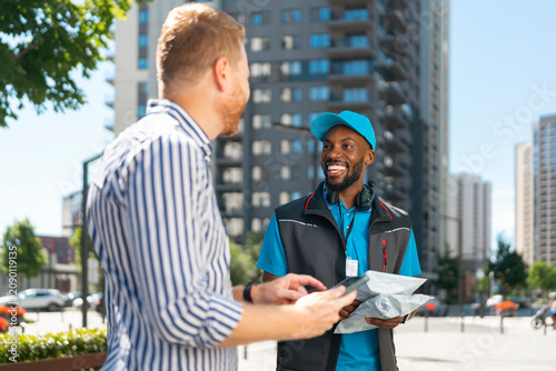 Customer signs digitally to confirm receipt of an online order during last-mile delivery.