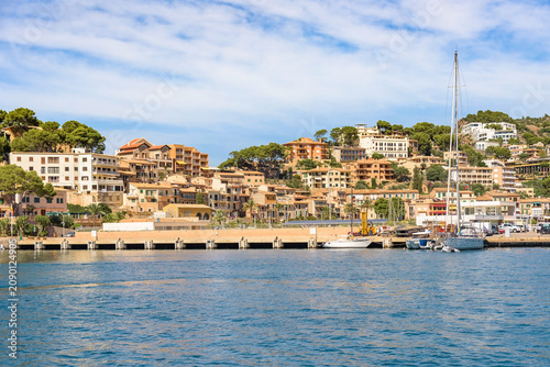 Port de Soller harbour with Mediterranean hillside buildings and moored boats, Mallorca