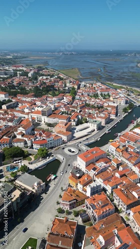 Elevated drone view looking down at Aveiro city streets, central river and iconic boats