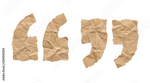 Crumpled paper quotation marks isolated on white background.