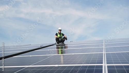 Technician installing rooftop solar panels for green energy, supporting renewable energy, clean power, sustainable technology and solar infrastructure.