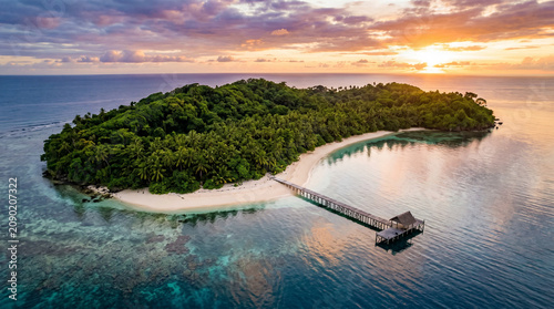Tropical Island Paradise: Aerial View of Lush Green Island with White Sand Beach and Jetty at Sunset