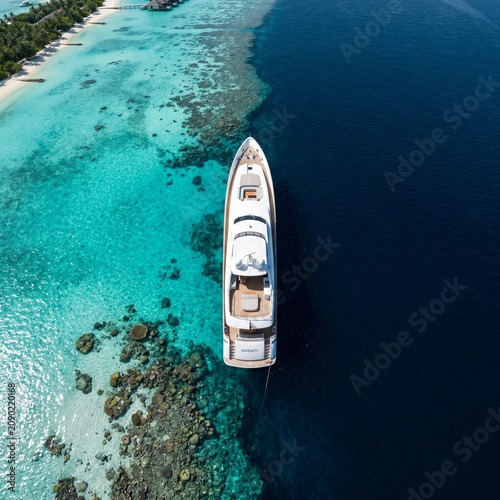 Luxury Yacht Anchored in Turquoise Tropical Ocean, Aerial View