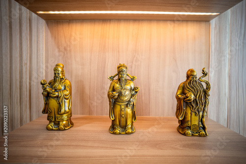 Photography Gold Fu Lu Shou, the three Chinese gods of fortune, prosperity, and longevity, stand as majestic golden statues in a traditional temple celebrating culture and blessings