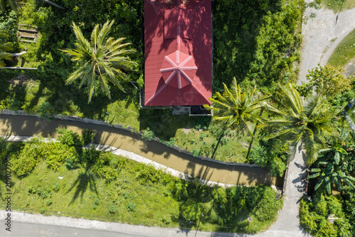 Red-Roofed Building, Canal, and Road in Tropical Village in Aceh, Sumatra, Indonesia