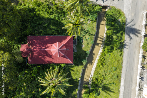Red-Roofed Building, Canal, and Road in Tropical Village in Aceh, Sumatra, Indonesia