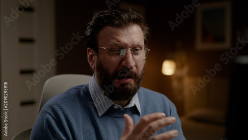 Tableau sur toile Disgusted man with glasses in home office. Close-up