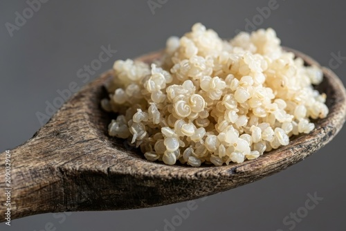 Cooked White Quinoa on Rustic Wooden Spoon for Healthy Nutrition and Vegan Meal Planning Macro Background with Wellness Vibe and Organic Food Copy Space
