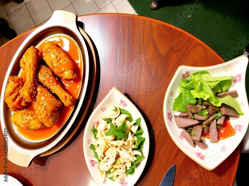 A top down view of a delicious table spread featuring fried chicken and various side dishes served