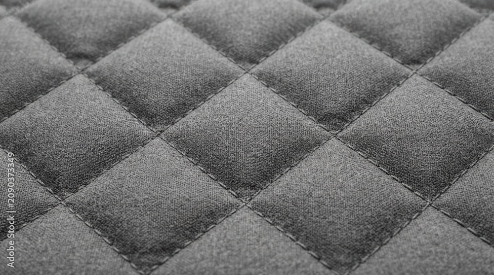 Fototapeta premium Grey Quilted Fabric Texture Close Up Featuring Diamond Pattern Stitching for Luxury Interior Design Backgrounds and Upholstery Projects