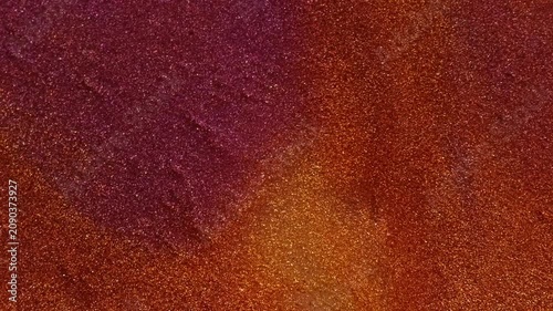 Shimmer ink mix. Glitter texture. Defocused purple orange colorful chemical droplet liquid leaking on abstract acrylic art background.