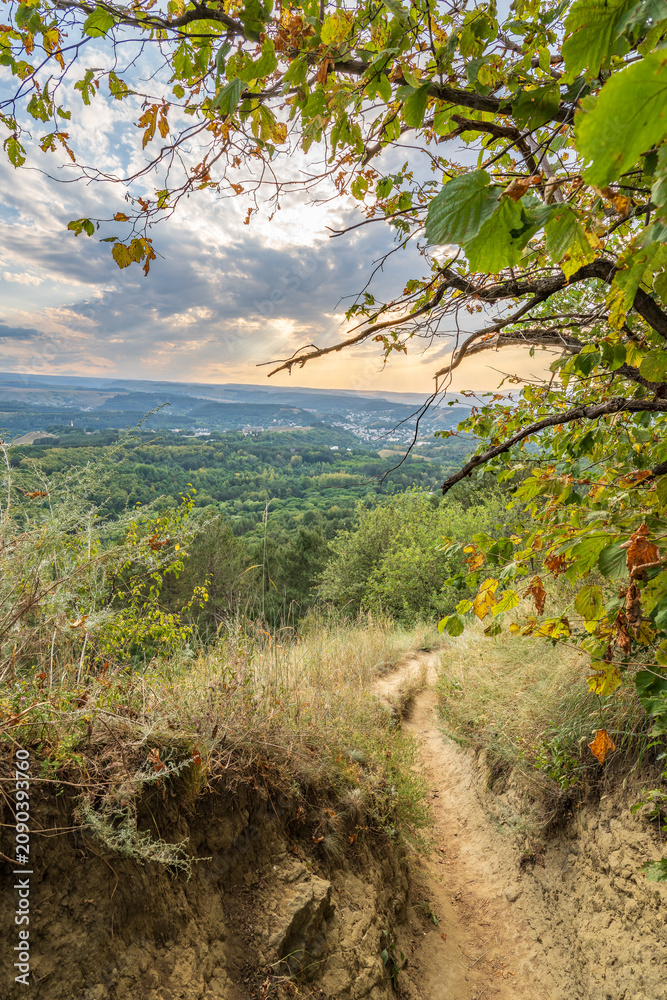 Fototapeta premium Curve road to the mountains. Scenic dirt road with mountain range.