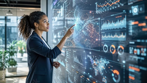 Analyzing Data Stream woman interacts with a futuristic wall display showcasing complex data visualizations and global analytics, representing innovation and technological advancement.