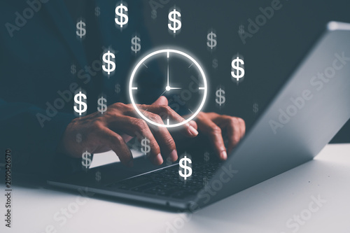 Fotografía Hands typing on a laptop keyboard with floating dollar signs and a clock, symbolizing time management and money-making through work or business