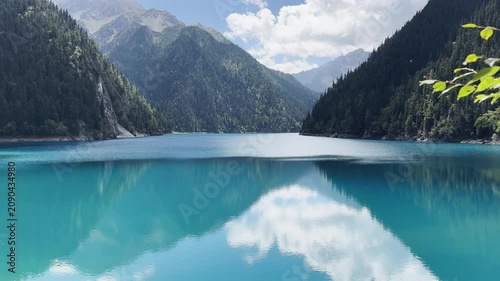 Breathtaking 4K Slow Motion Shot of Pristine Turquoise Lake and Mountain Reflection at Jiuzhaigou National Park Sichuan China, Serene Nature Landscape