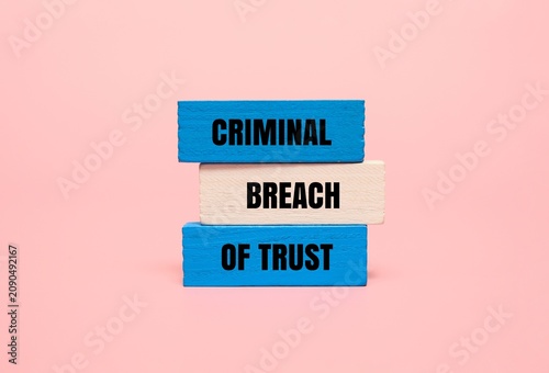 Photos Colorful blocks with the text CRIMINAL BREACH OF TRUST
