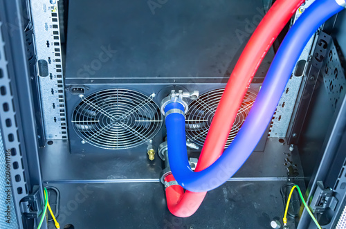 Photos server racks with a liquid cooled supercomputer system with tube