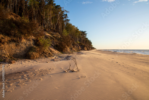 Golden sunset light on the beach in Dziwnowek, Poland