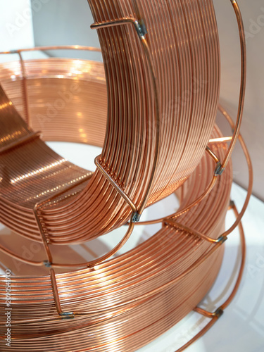Large spools of copper welding wire. Used for automatic robotic welding in factories and workshops.