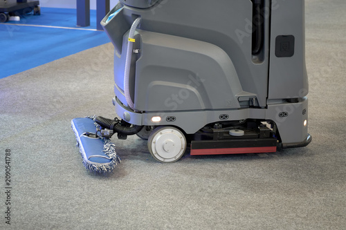 Foto Automated appliance cleaning the carpet floor. Selective focus.
