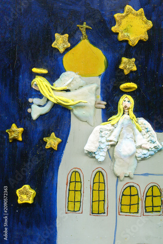 A child's drawing of a Christian church and flying angels. Christmas Eve.